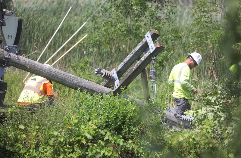 In this July 2024 file photo, crews work to repair power lines on Eastern Boulevard downed by a tornado that touched down in Canandaigua.