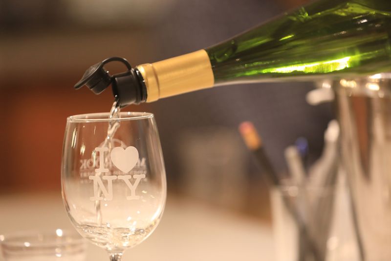 A bottle of riesling is poured during a wine tasting at Millbrook Vineyards on August 1, 2024.