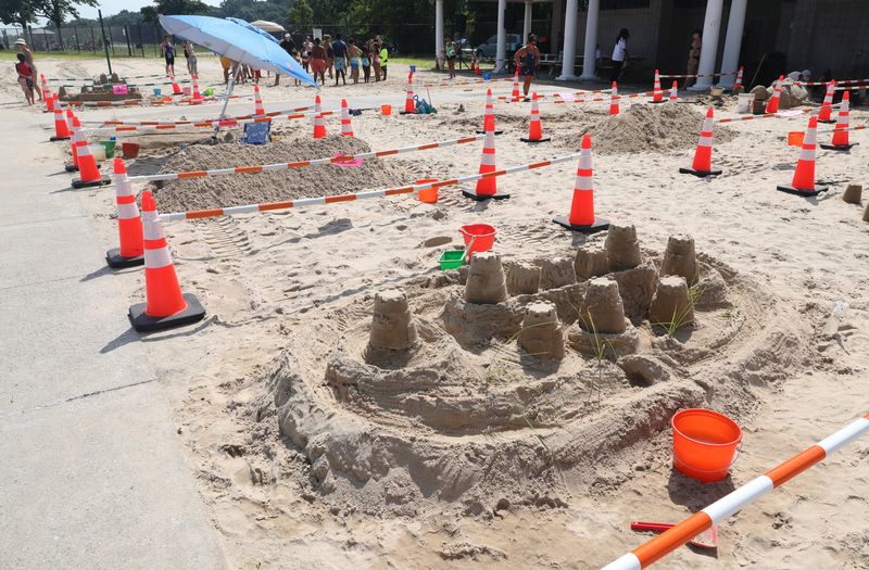 Teams create their sand creations during the 10th annual Glen Island Sand Art Competition at Glen Island Park in New Rochelle, Aug. 3, 2024. About 15 teams competed for trophies and gift certificates for first, second and third place. The event was sponsored by the Westchester County Department of Parks, Recreation and Conservation.