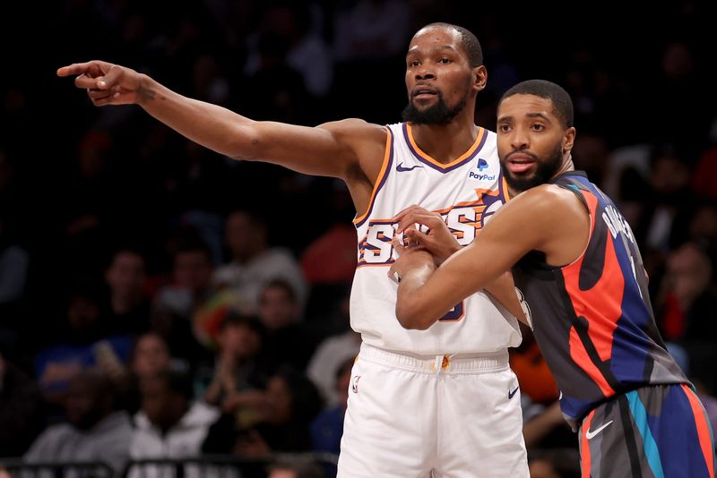 Jan 31, 2024; Brooklyn, New York, USA; Brooklyn Nets forward Mikal Bridges (1) defends Phoenix Suns forward Kevin Durant (35) during the fourth quarter at Barclays Center. Mandatory Credit: Brad Penner-USA TODAY Sports