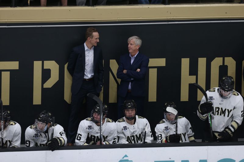 Zach McKelvie, left, will take over Army hockey head coaching duties from Brian Riley, right, for the 2025-26 season. ARMY ATHLETICS