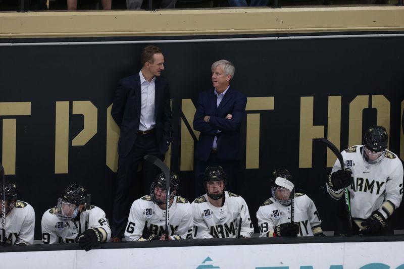 Zach McKelvie, left, will take over Army hockey head coaching duties from Brian Riley, right, for the 2025-26 season. ARMY ATHLETICS