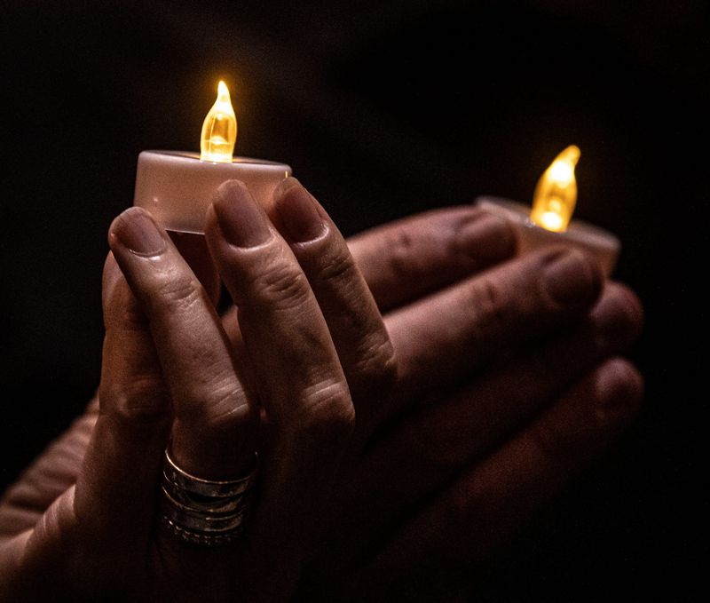 People hold candles during the Westchester Countywide October 7th Commemoration at Temple Israel Center in White Plains N.Y. during Oct. 6, 2024. Elected officials and over one-thousand people attended the commemoration marking one year since Hamas attacked southern Israel, killing 1,200 people and taking hundreds of hostages.