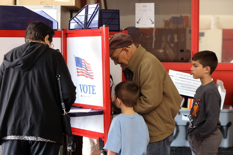 Tony Dinis, 78, of Tarrytown votes with his grandchildren beside him at Tarrytown Fire Department polling place on Election Day Nov. 5, 2024.