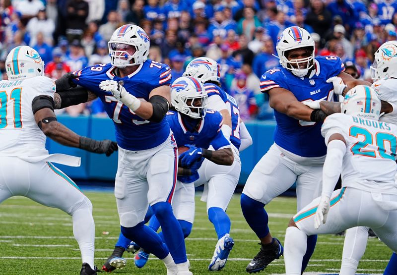 Bills offensive linemen Spencer Brown and O'Cyrus Torrence create a hole for running back James Cook during second half action at Highmark Stadium on Nov. 3, 2024.