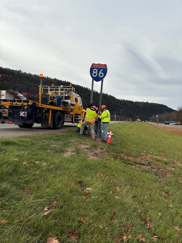 New York State Department of Transportation workers install an “Interstate 86" sign following a press conference in Owego on Thursday, Nov. 14, 2024.