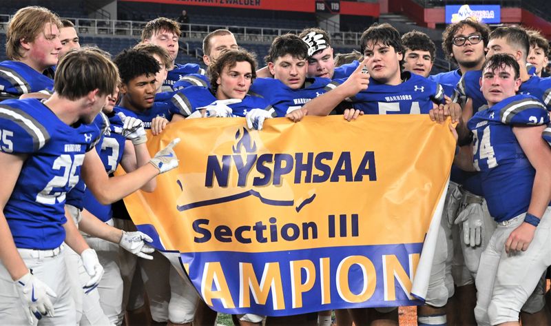Whitesboro football players hoist Section III's championship banner after beating Corcoran in the 2024 Class A title game in the JMA Wireless Dome in Syracuse. With seeds set for the playoffs, 31 teams begin the quest to win 2025 championships Thursday.