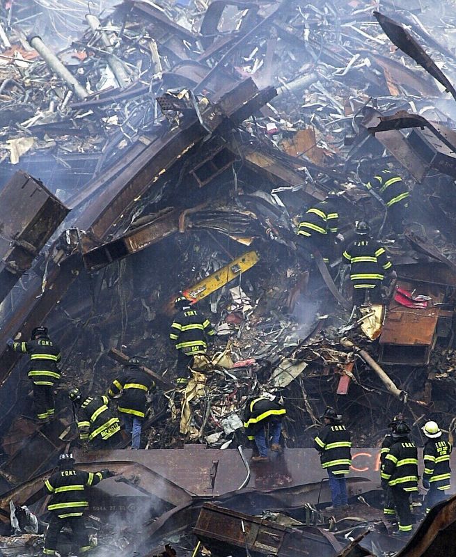 Like ants on an anthill FDNY firefighters climb through the rubble in search of the missing in ground zero of the World Trade Center disaster Sept. 12, 2001.