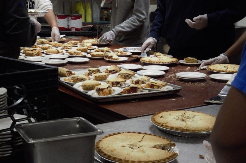 Binghamton High School students prepare for their annual Thanksgiving community dinner in November 2024, decorating the cafeteria and seeing to last-minute details to ensure a full dining experience.