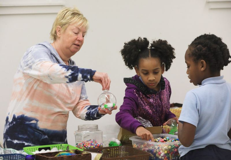 Carrie Decker from Crazy Over ART on Tour leads an ornament making workshop with, from left, Natalia Mima and Jonas Wilcox during a session sponsored by Charlia Frank Inc on December 4, 2024.