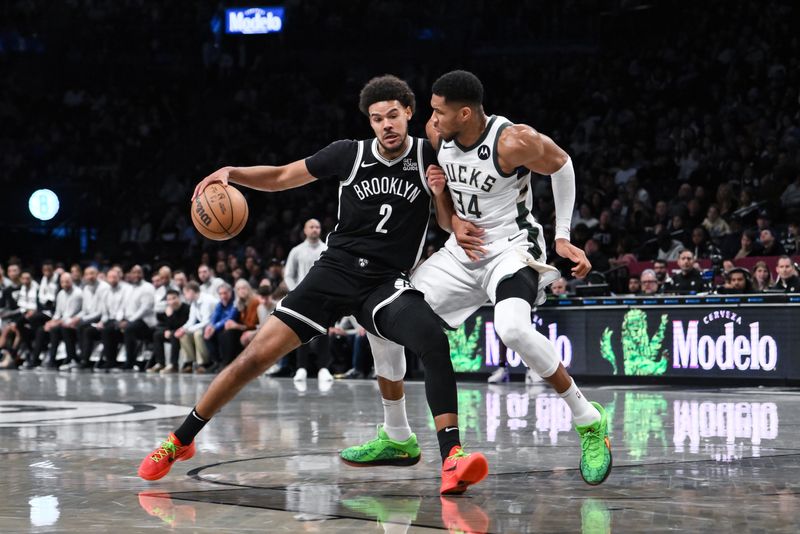 Dec 8, 2024; Brooklyn, New York, USA; Brooklyn Nets forward Cameron Johnson (2) drives to the basket while being defended by Milwaukee Bucks forward Giannis Antetokounmpo (34) during the first half at Barclays Center. Mandatory Credit: John Jones-Imagn Images