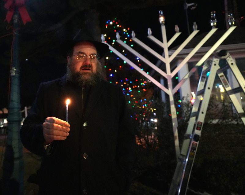 Rabbi Chaim Zvi Ehrenreich of Chabad of the Nyacks lights the Hanukkah menorah at Braunsdorf Park in Pearl River Dec. 26, 2024.