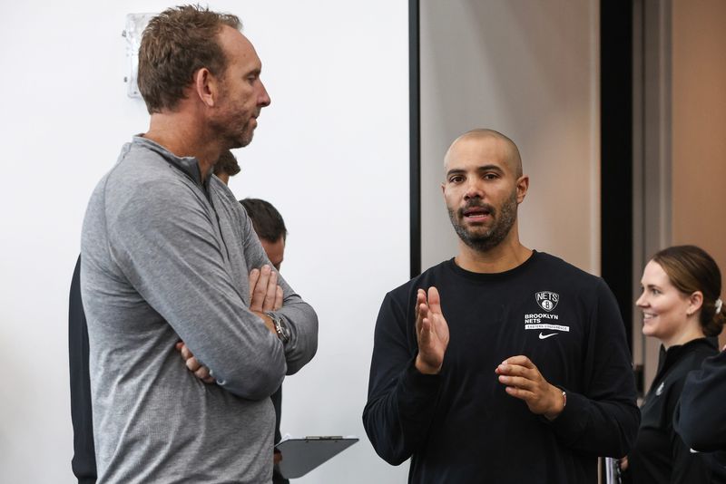 Sep 30, 2024; Brooklyn, NY, USA; Brooklyn Nets General Manager Sean Marks (left) speaks to head coach Jordi Fernandez (right) during media day at HSS Training Center. Mandatory Credit: Wendell Cruz-Imagn Images