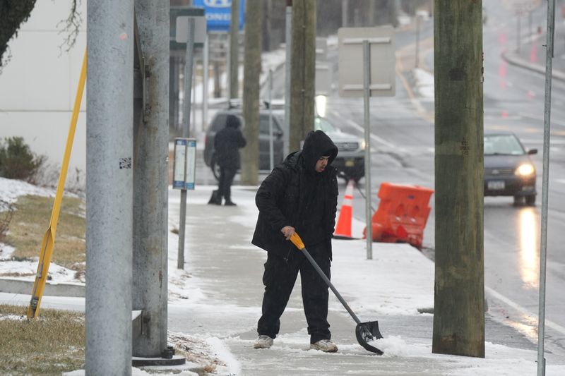 Shovelers clear the sidewalk on Broadway in freezing rain conditions Feb. 6, 2025 in Tarrytown. The National Weather Service issued a winter weather advisory for Westchester, Rockland and Putnam counties with up to two inches of snow and sleet accumulation expected.