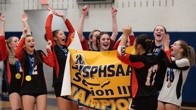 Rome Free Academy celebrates with the Section III championship banner after defeating New Hartford 3-2 in the 2025 Class A winter volleyball final at Central Valley Academy. New Hartford and Rome Free Academy  have met in the sectional finals the last two years with each winning once, and they are the top two seeds again this year.