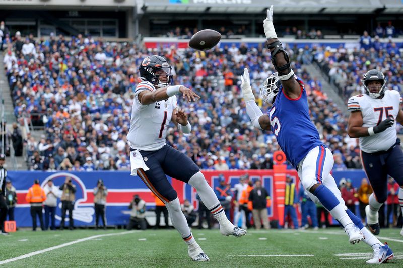 Oct 2, 2022; East Rutherford, New Jersey, USA; Chicago Bears quarterback Justin Fields (1) throws a pass against New York Giants linebacker Kayvon Thibodeaux (5) during the second quarter at MetLife Stadium. Mandatory Credit: Brad Penner-USA TODAY Sports