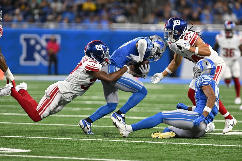 Aug 11, 2023; Detroit, Michigan, USA; Detroit Lions running back Jahmyr Gibbs (26) gets tackled by New York Giants cornerback Tre Hawkins III (37) after catching a pass in the first quarter at Ford Field. Mandatory Credit: Lon Horwedel-USA TODAY Sports