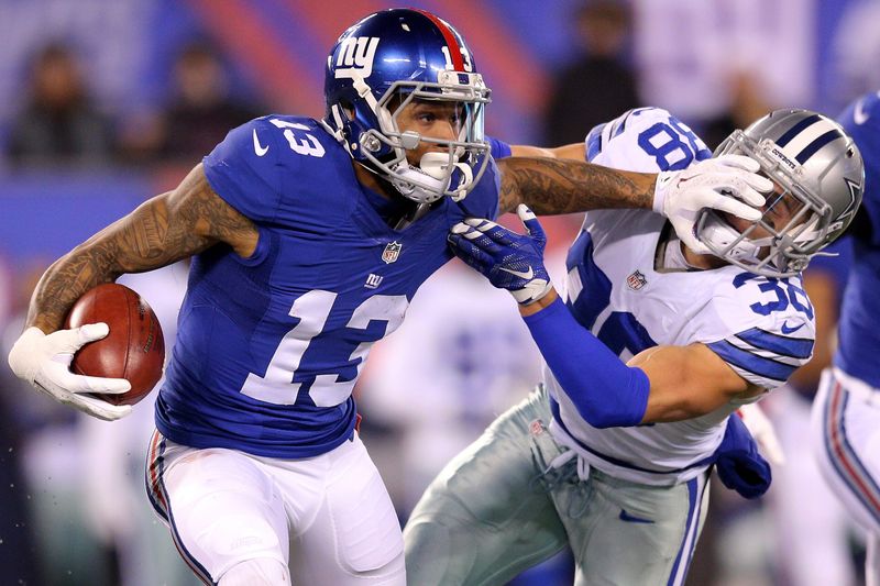 Dec 11, 2016; East Rutherford, NJ, USA; New York Giants wide receiver Odell Beckham Jr. (13) stiff arms Dallas Cowboys safety Jeff Heath (38) during the third quarter at MetLife Stadium. Mandatory Credit: Brad Penner-USA TODAY Sports