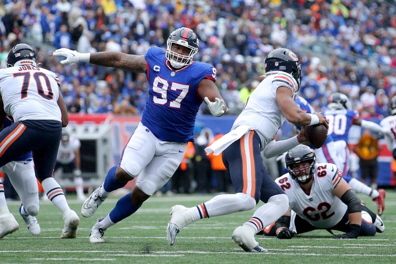 Oct 2, 2022; East Rutherford, New Jersey, USA; New York Giants defensive tackle Dexter Lawrence (97) pressures Chicago Bears quarterback Justin Fields (1) during the second quarter at MetLife Stadium. Mandatory Credit: Brad Penner-USA TODAY Sports
