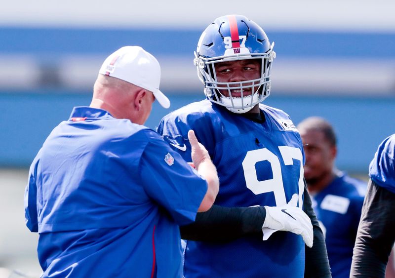 Jul 25, 2019; East Rutherford, NJ, USA; New York Giants defensive tackle Dexter Lawrence (97) talks with defensive coordinator James Bettcher during the first day of training camp at Quest Diagnostics Training Center. Mandatory Credit: Vincent Carchietta-USA TODAY Sports