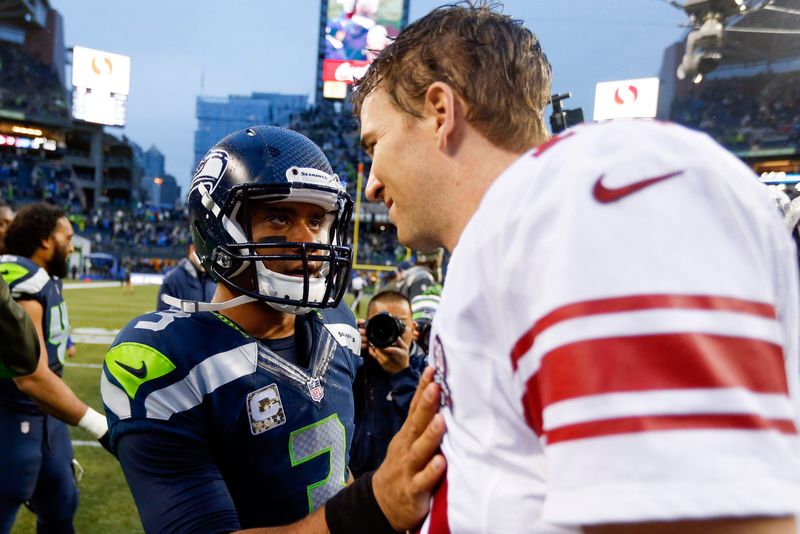 Nov 9, 2014; Seattle, WA, USA; Seattle Seahawks quarterback Russell Wilson (3) talks with New York Giants quarterback Eli Manning (10) following a 38-17 Seattle victory at CenturyLink Field. Mandatory Credit: Joe Nicholson-USA TODAY Sports