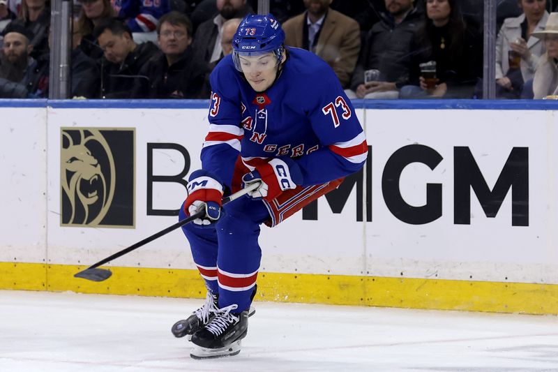 Mar 3, 2025; New York, New York, USA; New York Rangers center Matt Rempe (73) plays the puck against the New York Islanders during the third period at Madison Square Garden. Mandatory Credit: Brad Penner-Imagn Images