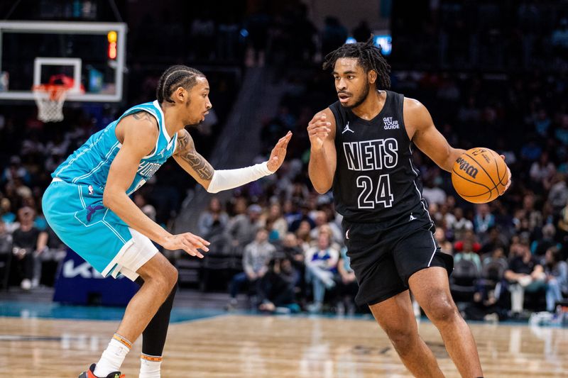 Mar 8, 2025; Charlotte, North Carolina, USA; Brooklyn Nets guard Cam Thomas (24) drives on Charlotte Hornets guard Nick Smith Jr. (8) during the second quarter at Spectrum Center. Mandatory Credit: Scott Kinser-Imagn Images