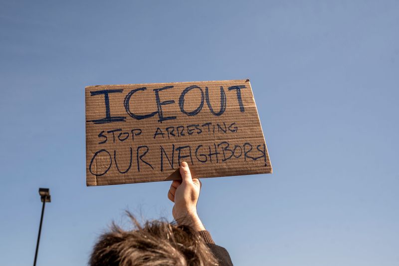 People hold protest signs during a rally in opposition to ICE on Tuesday, Mar. 11, 2025. Community activists gather after ICE released a statement last week announcing the opening of Delaney Hall in Newark, NJ as a detention center.
