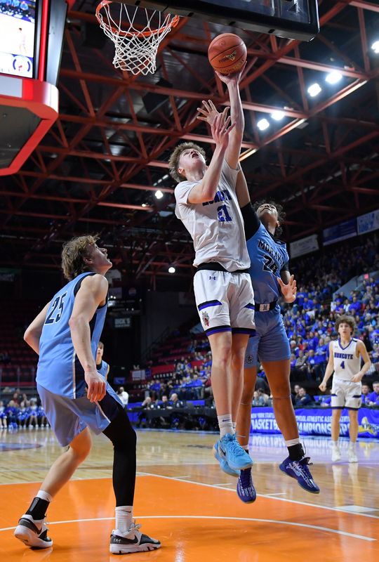 Honeoye's Landon Washburn, center, drives to the basket between Moravia's Joe Baylor, left, and Jairen Francis during a NYSPHSAA Class C Boys Basketball Championships semifinal in Binghamton, N.Y., Friday, March 21, 2025. Honeoye advanced to the Class C final with a 63-55 win over Moravia-IV.