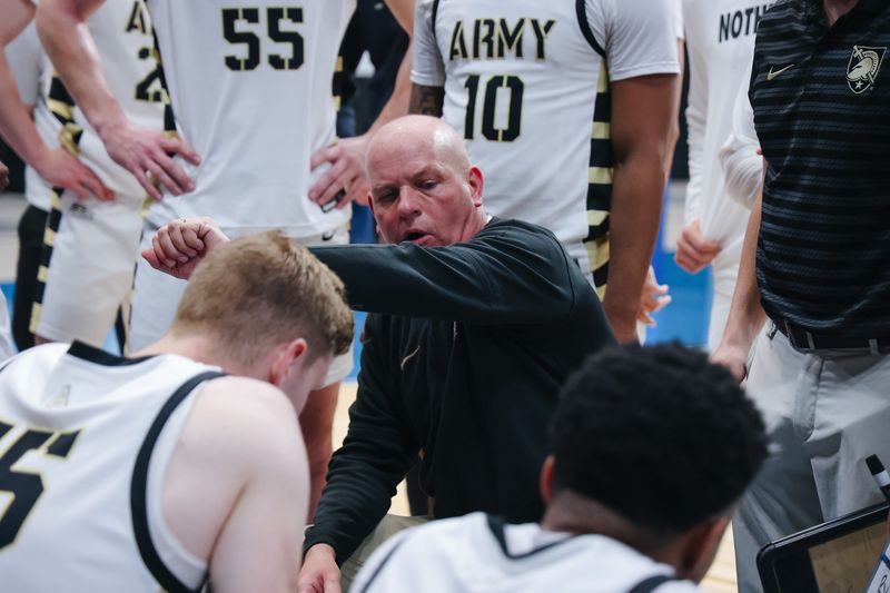 Army men's basketball second-year head coach Kevin Kuwik addresses the huddle at the College Basketball Invitational in Daytona Beach., Fla., on March 23, 2025. Army beat Elon 83-78 in the first round. ARMY ATHLETICS