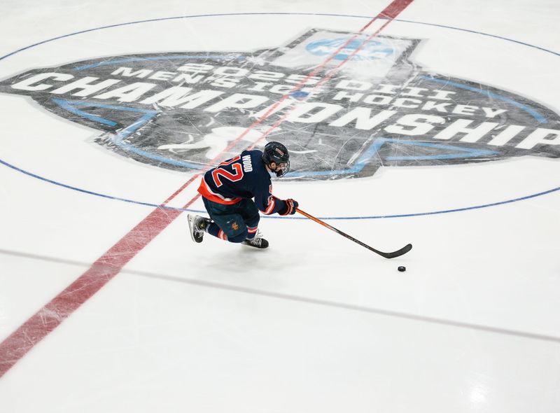 Utica University's Matt Wood advances the puck past the NCAA Division III Men's Ice Hockey Championship logo on the Nexus Center ice during the 2025 championship game in Utica.