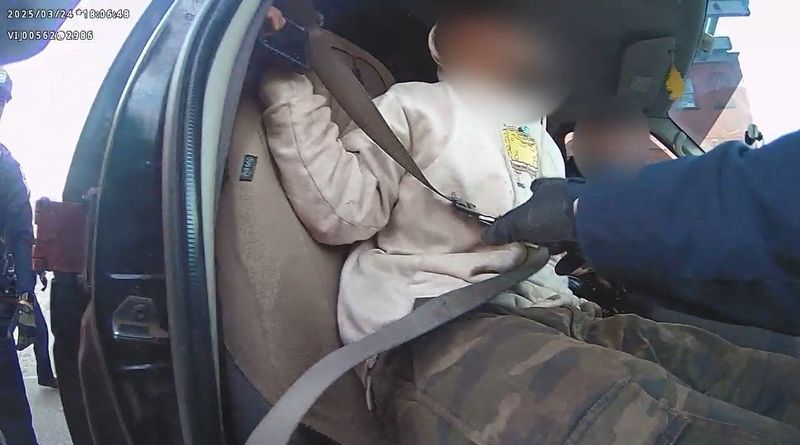 A screengrab of body worn camera footage from a controversial traffic stop shows Rochester police removing an individual from a van for federal immigration agents.