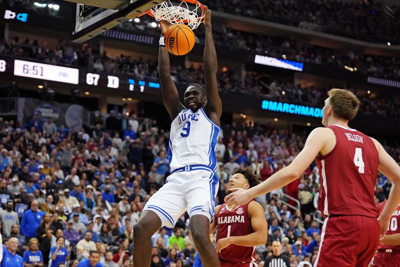 Mar 29, 2025; Newark, NJ, USA; Duke Blue Devils center Khaman Maluach (9) dunks the ball against Alabama Crimson Tide forward Grant Nelson (4) during the second half in the East Regional final of the 2025 NCAA tournament at Prudential Center. Mandatory Credit: Robert Deutsch-Imagn Images