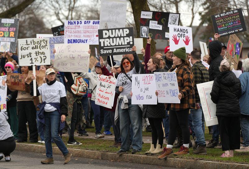Protesters gather along Culver Road near Cobbs Hill Park during an anti-Trump rally.