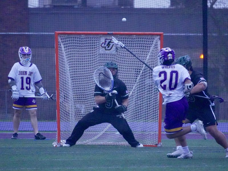 Yorktown goalie Hunter Mezzatesta locks in on a shot from John Jay's Nick Rinaldi during the Huskers' 6-2 win on Saturday, April 5, 2025 at John Jay High School in Cross River, N.Y.