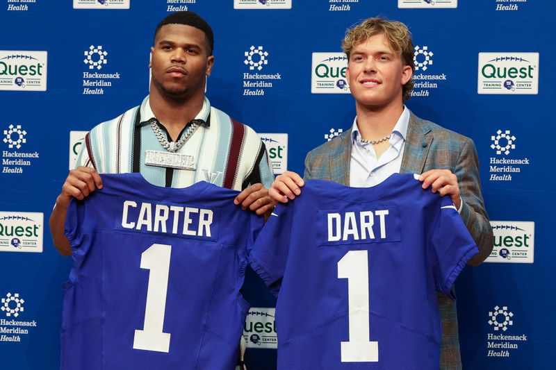 Apr 25, 2025; East Rutherford, NJ, US; New York Giants first round draft picks, Abdul Carter and Jaxson Dart pose for photos prior to the start of the press conference. Mandatory Credit: Thomas Salus-Imagn Images