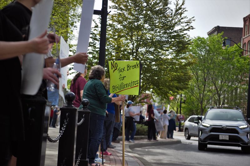 About a dozen people gathered on Court Street in downtown Binghamton on May 1, 2025 to protest the Trump administration and its policies.