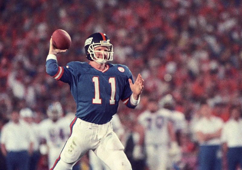Jan 25, 1987; Pasadena, CA, USA; FILE PHOTO; New York Giants quarterback Phil Simms (11) looks to throw against the Denver Broncos during Super Bowl XXI at the Rose Bowl. The Giants defeated the Broncos 39-20. Mandatory Credit: Bob Deutsch-USA TODAY Sports