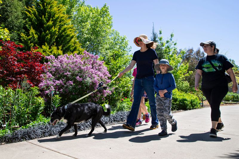 People walk at Inspiration Garden in Mountain Fir Park on Monday, May 5, 2025, in Independence, Ore.