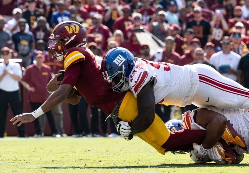 Sep 15, 2024; Landover, Maryland, USA; New York Giants defensive tackle Rakeem Nunez-Roches (93) tackles Washington Commanders quarterback Jayden Daniels (5) in the second half at Commanders Field. Mandatory Credit: Luke Johnson-Imagn Images