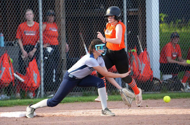 Mercy’s Brenna Ray stretches to get Wellsville hitter Ayla Faulkner at first base.