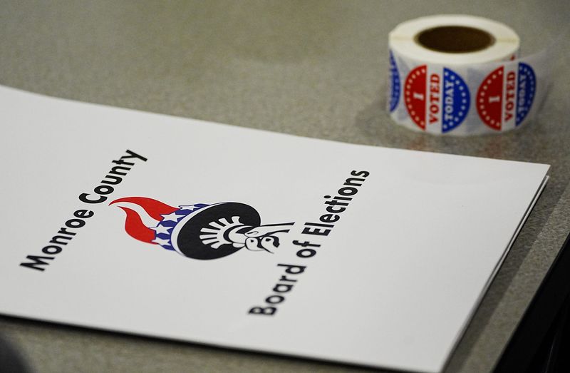 "I Voted" stickers and a Monroe County Board of Elections folder sit on a table near some election inspections. Residents were voting on the Greece Central School District’s budget at the Transportation & Support Services Facility on Latta Road in Greece on May 20, 2025.