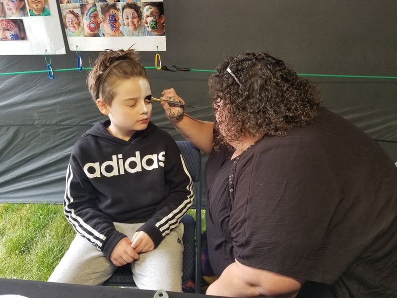 A young visitor to Hornell’s Wildflower Festival takes on a new identity with custom face painting on Saturday, May 24, 2025.