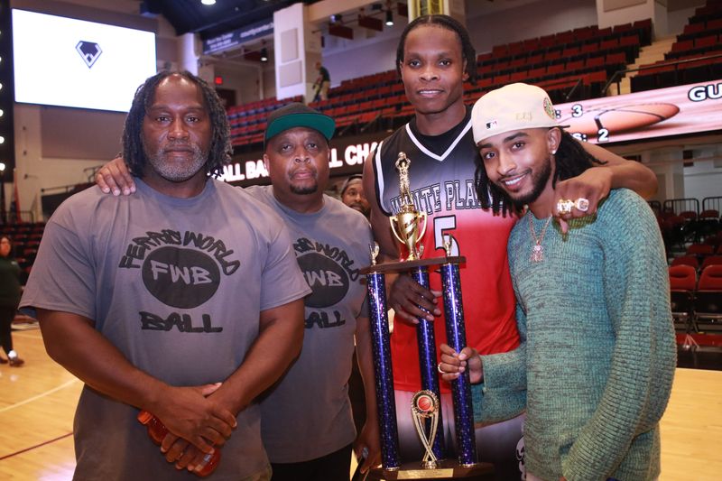 Kevin "Higgszy" Higgs, left, and Gerard "Oopie" Seward, the co-directors of Ferris World Ball, present Romaine Thomas with the championship MVP trophy at the Westchester County Center on Aug. 11, 2024, Ferris World Ball championship night. Thomas was on Team Gunhill, the Ferris champion three of the past four years. To his left is Rashon Kamari of Elegant Empire Jewelers, which made the MVP ring.