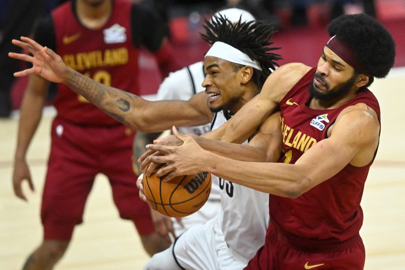 Mar 11, 2025; Cleveland, Ohio, USA; Brooklyn Nets center Nic Claxton (33) and Cleveland Cavaliers center Jarrett Allen (31) reach for the ball in the third quarter at Rocket Arena. Mandatory Credit: David Richard-Imagn Images