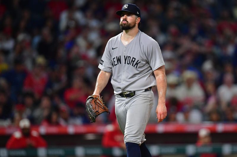 New York Yankees pitcher Carlos Rodon (55) reacts after striking out Los Angeles Angels left fielder Chris Taylor (33) to end the seventh inning at Angel Stadium in Anaheim, California.
