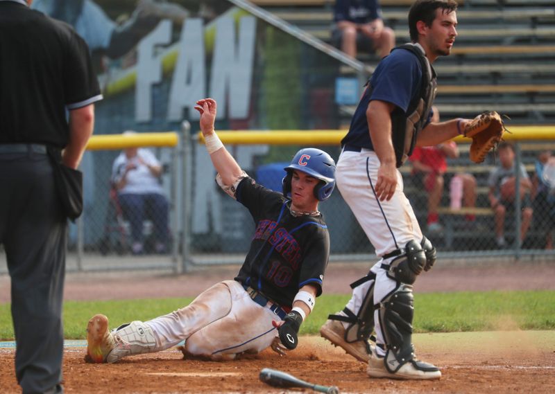 Chester's James Musco slides safe into home plate behind Solvay's AJ Trendell during the New York State Class C baseball playoff game on June 5, 2025.