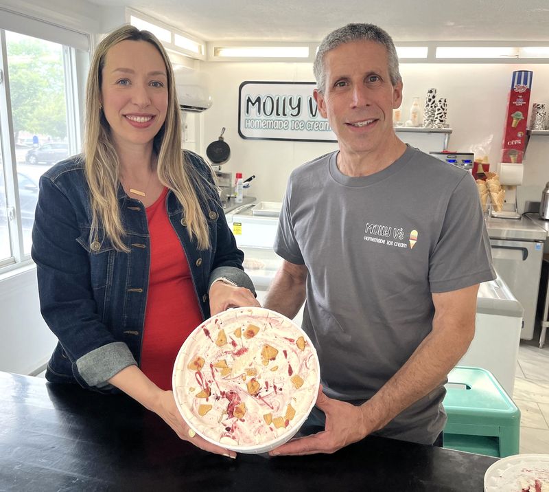 Contest winner Rachel Bateman is pictured with a tub of Gramma's Cookie Drawer and Molly V'S Homemade Ice Cream owner Mike Vistocco.