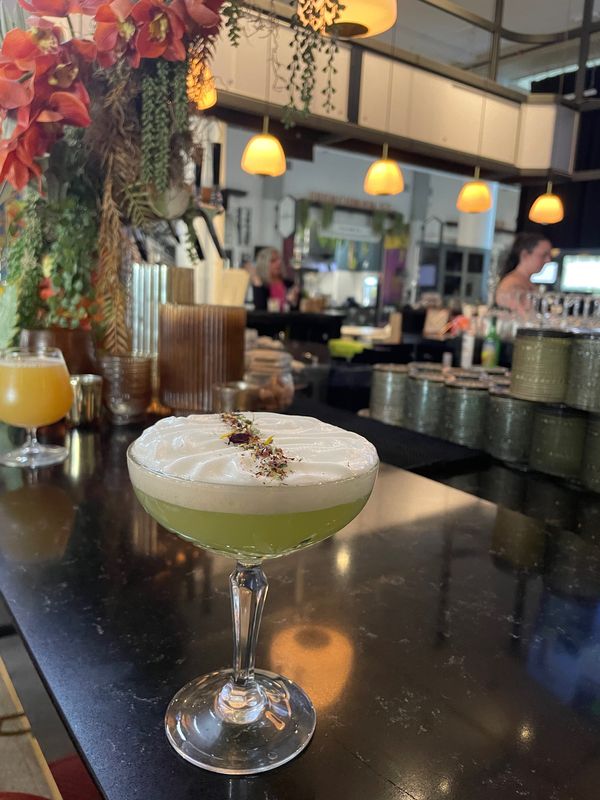 The Garden, a summertime seasonal cocktail, is served at the bar of La Bola in Sibley Square in downtown Rochester. It's made with gin, cucumber, basil foam and dehydrated edible flowers.