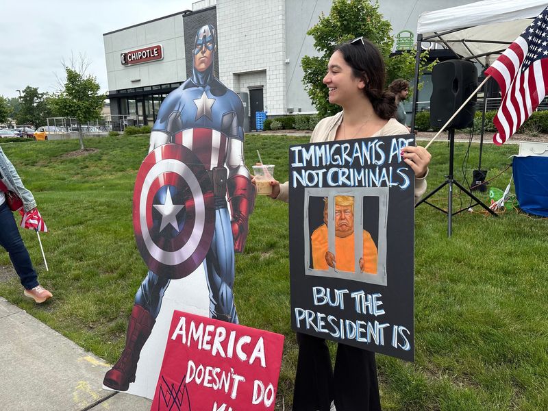 Penelope Tsetsekos of Pearl River holds a handmade sign painted with the words "IMMIGRANTS ARE NOT CRIMINALS BUT THE PRESIDENT IS" at a No Kings protest June 14, 2025 in Nanuet.